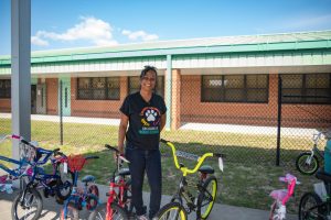 Dr. Nisha Phillip Malahoo with donated bicycles outside her school